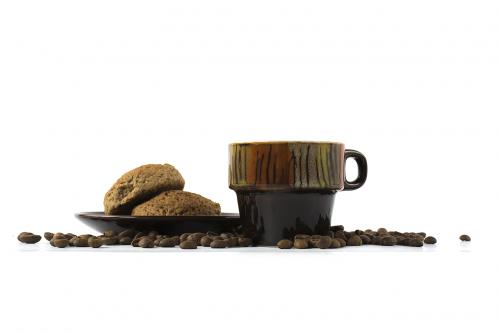 A cup of coffee with cookies isolated on white