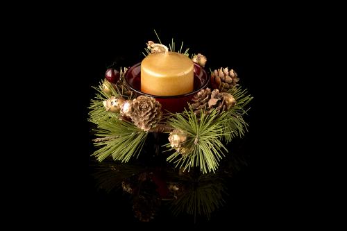 Christmas New Year composition with candle on a black mirror sur