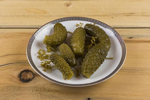 Salted cucumbers on a wooden table
