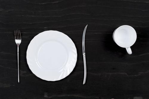 White crockery on a black wooden surface
