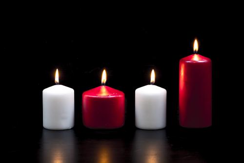 White and red candles on black background