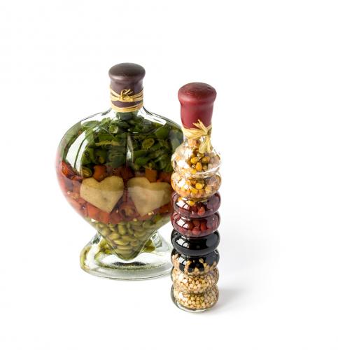 Decorative salted seeds in a glass bottles isolated on white