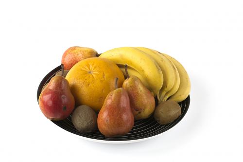 Some fruits on a large dish isolated on white
