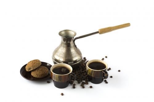 Two cups of coffee with cookies and turk isolated on white