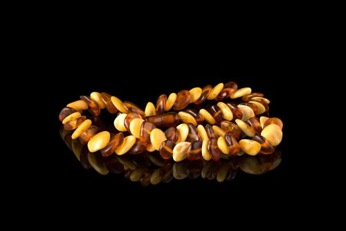 Amber necklace on a black mirror surface