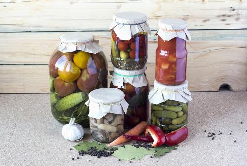 Salted tomatoes, cucumbers, mushrooms and lecho in a glass banks